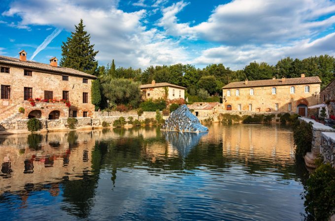 Thermal bath town of Bagno Vignoni, Italy during sunrise. Old thermal baths in the medieval village Bagno Vignoni, Tuscany, Italy. Medieval thermal baths in village Bagno Vignoni, Tuscany, Italy